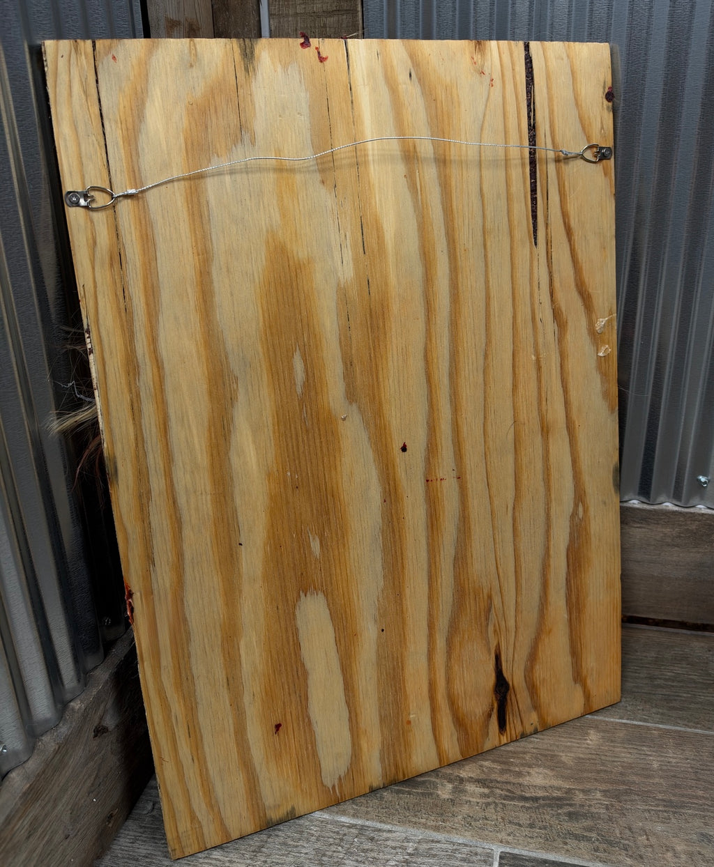 Back of the plywood Bludgeoned Smashed Face prop showing hanging hardware