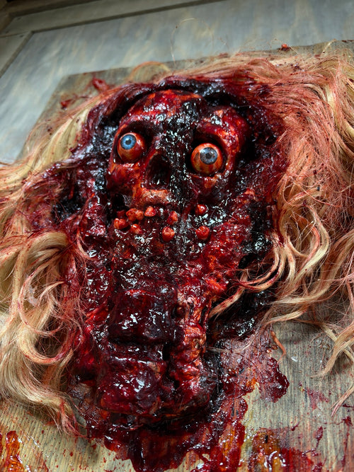 Close-up of the handmade Bludgeoned Smashed Face horror prop
